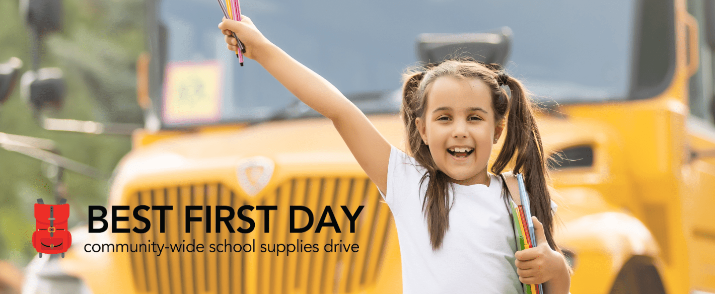 Best First Day-4 (1) Girl excited with pencil crayons and books for school out front of a school bus with Best First Day community wide school supplies drive campaign logo